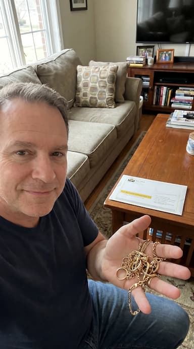 Customer showing gold chains and appraisal kit in living room