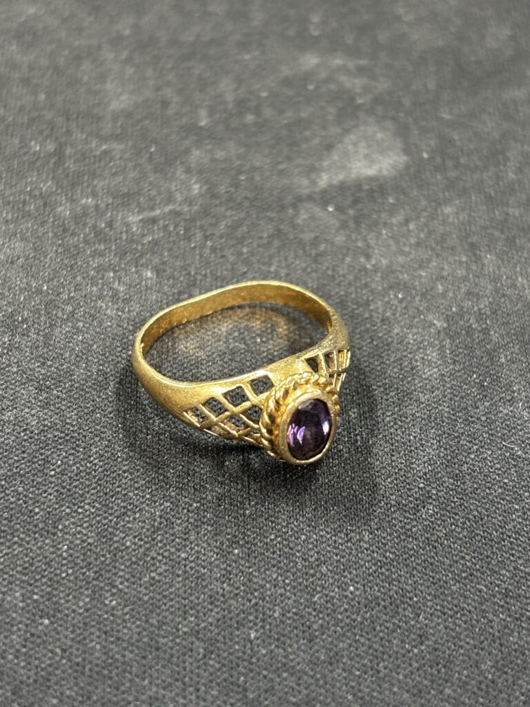Customer gold ring with purple gemstone sent in for gold payout